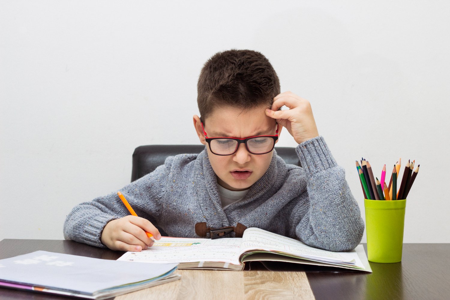 child with ADHD struggling to concentrate on homework