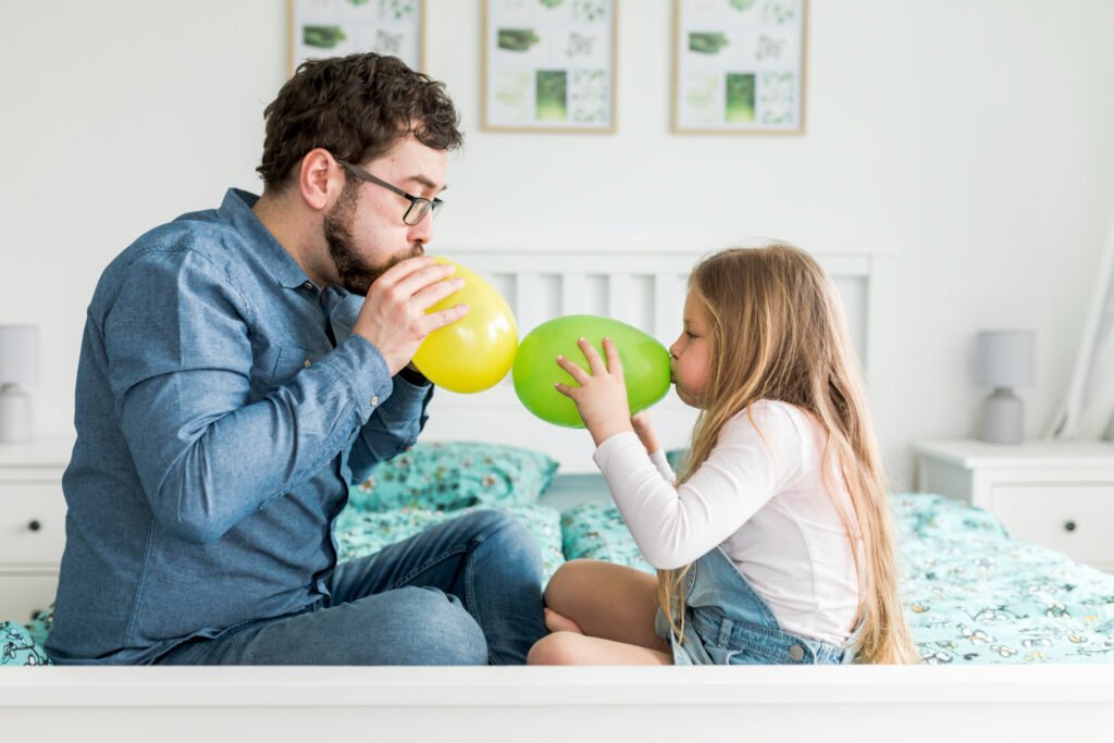 Parent and child playing balloon tennis for coordination training