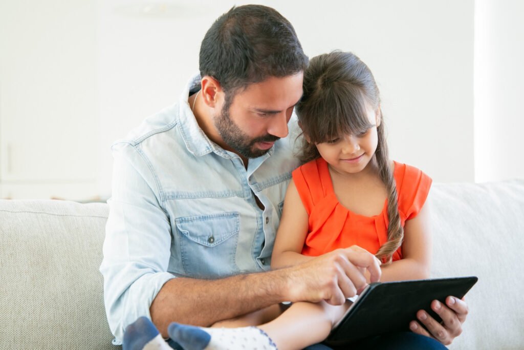 Parent and child engaged in focused screen activity