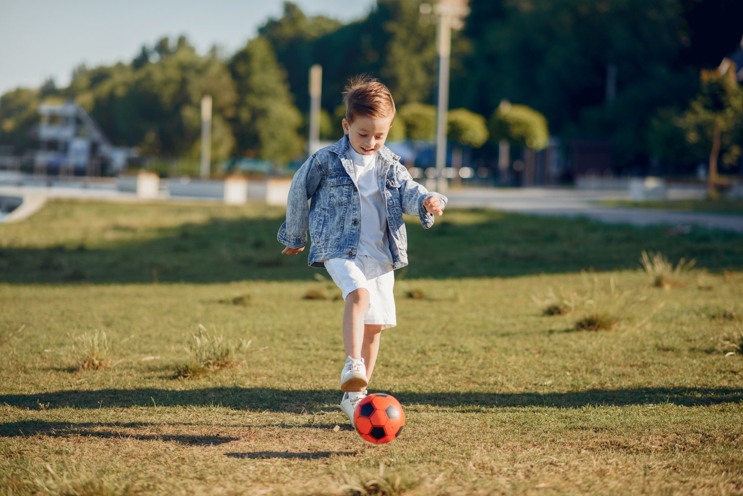 Young child practicing hand-eye coordination outdoors