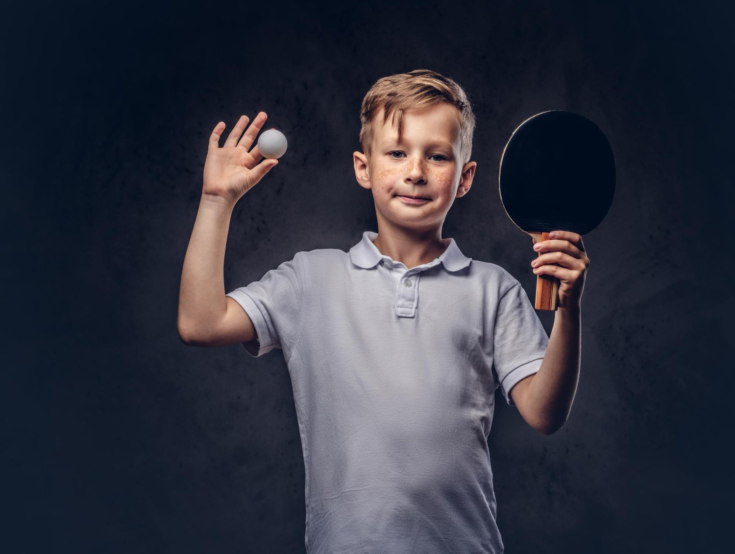 Young child playing table tennis to build reaction time