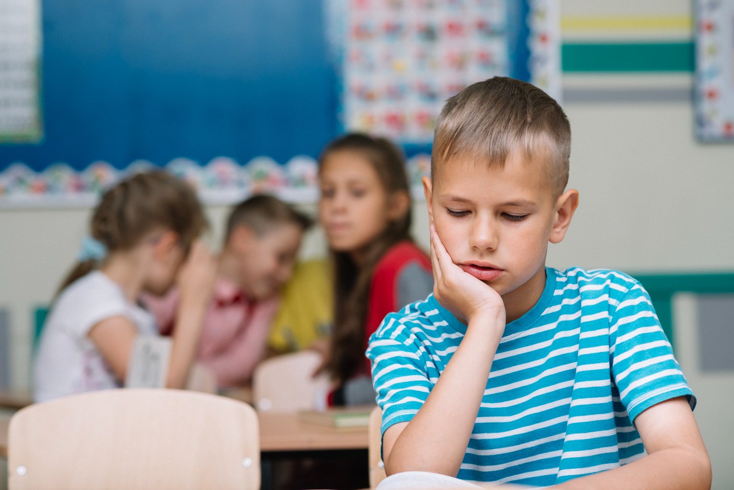 young boy classroom unable to sit still fidgeting